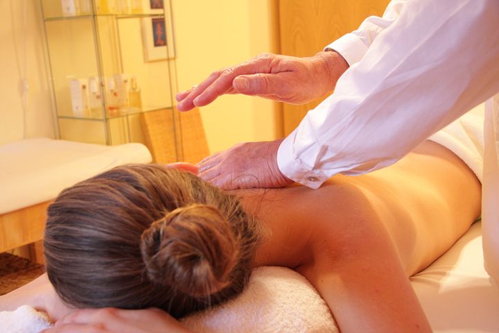 physiotherapist's hand massaging a woman